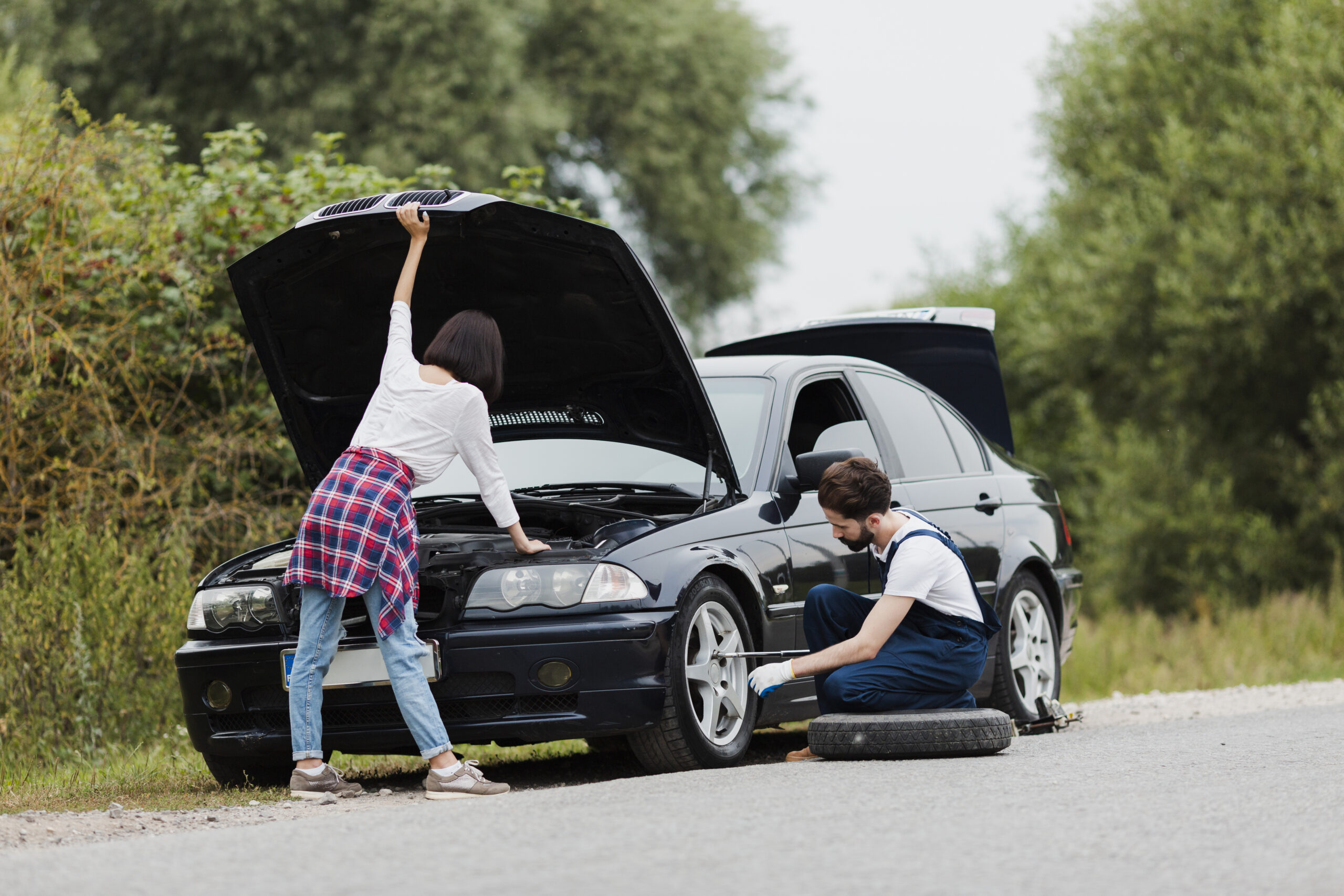 woman-checking-engine-man